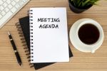 Meeting agenda text on note pad
